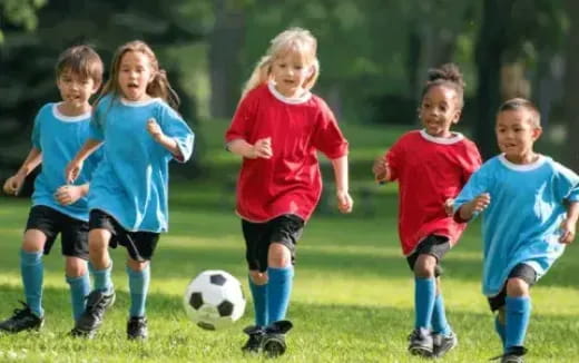 a group of kids playing football