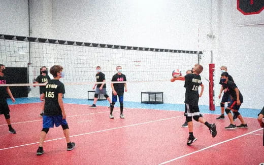 a group of people playing volleyball