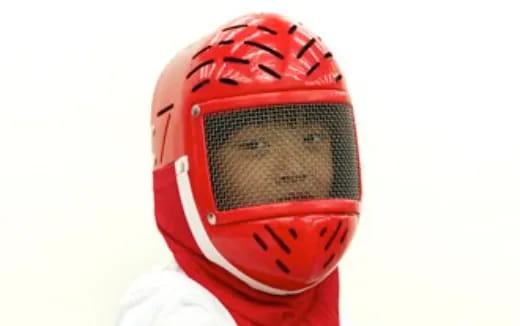 a person wearing a red and white shoe