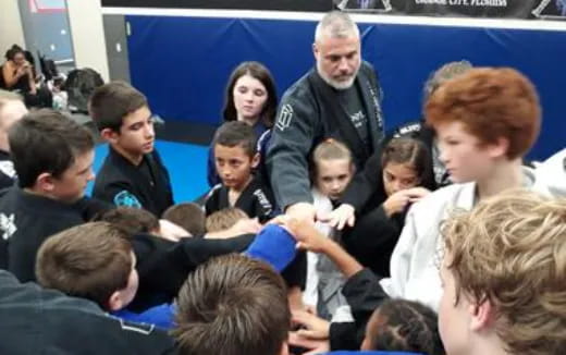 a person standing in front of a group of children
