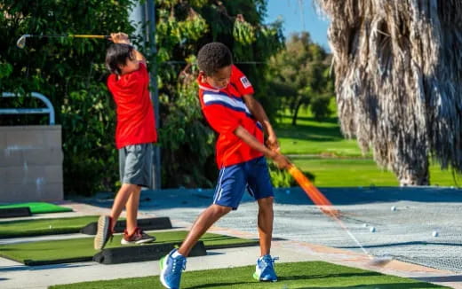 a couple of boys playing with a stick