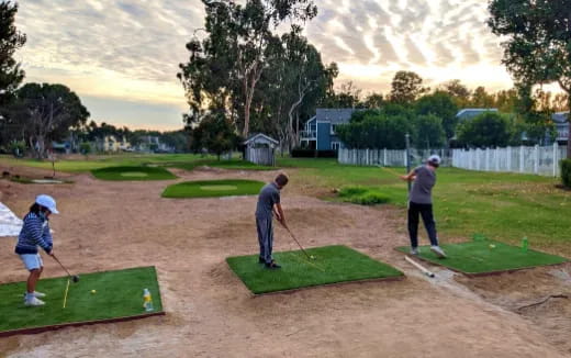 a group of people playing golf