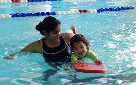 a person and a child in a pool