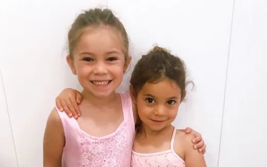 a couple of girls posing for the camera