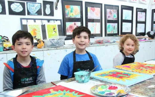 a group of children sitting at a table