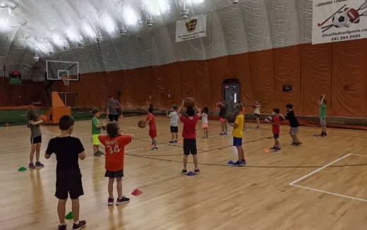 a group of kids playing basketball