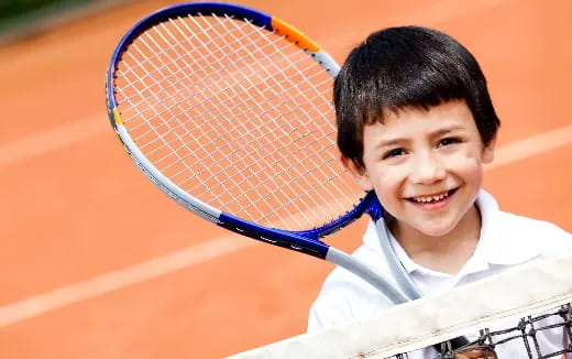 a boy holding a tennis racket