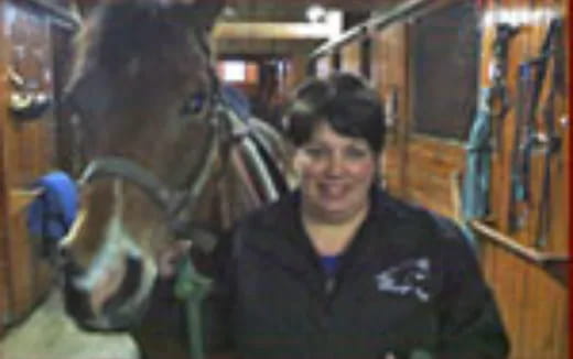 a man standing next to a horse