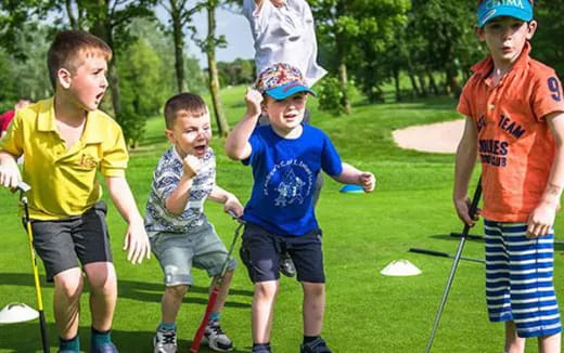 a group of boys playing golf