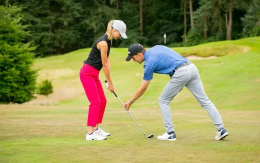 a man and a woman playing golf
