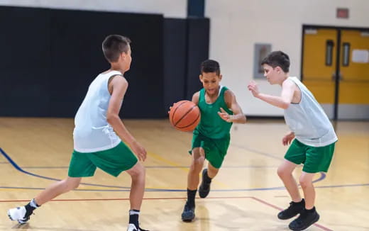 a group of boys playing basketball