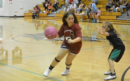 a group of girls playing basketball
