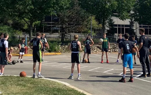 a group of people playing basketball