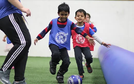 a group of kids playing football