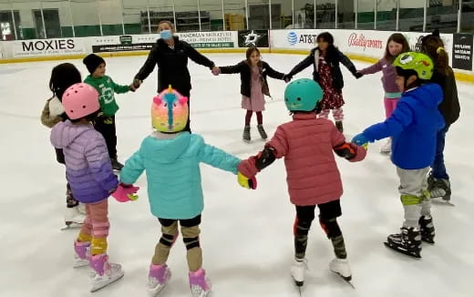 a group of children ice skating