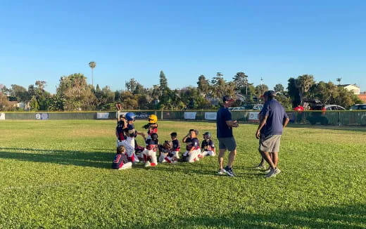 a group of people playing baseball