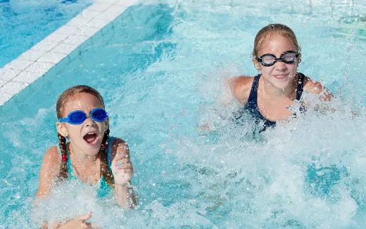 a couple of kids in a pool