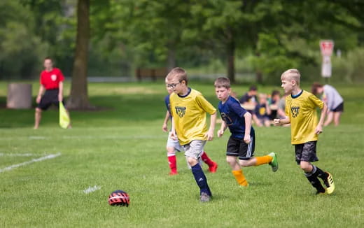 a group of kids playing football