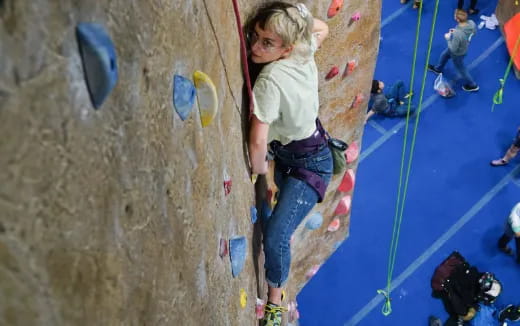 a girl climbing a rock wall