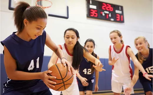 a group of women playing basketball