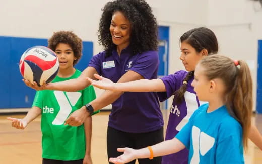 a group of women playing volleyball