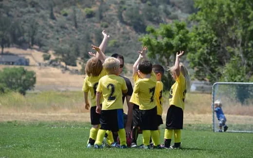 a group of kids in yellow uniforms