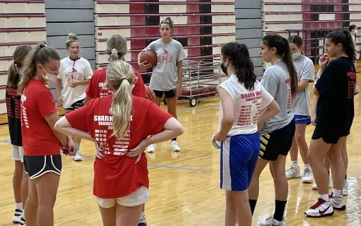 a group of girls playing basketball