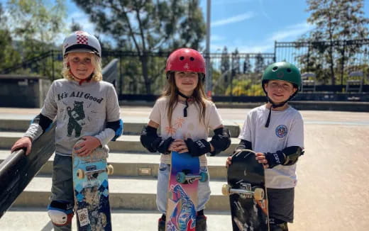kids with skateboards on a bench