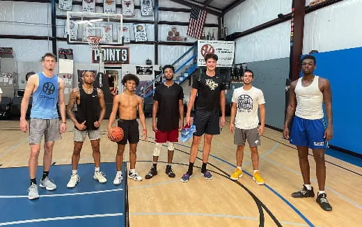 a group of people standing on a basketball court