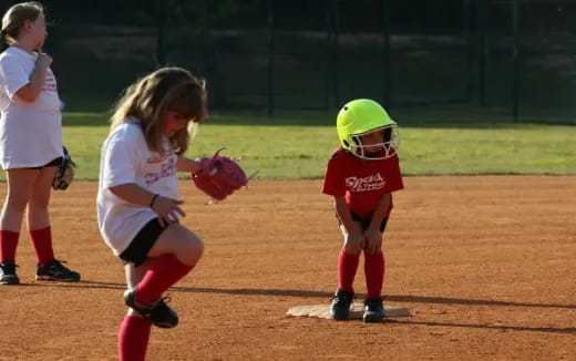 kids playing baseball on a field