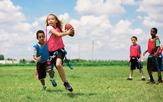 a group of kids playing football