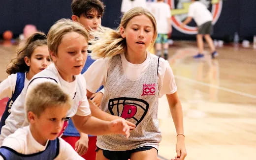 a group of kids playing basketball