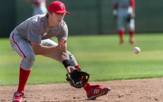 a baseball player about to catch a baseball