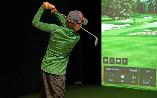 a person swinging a golf club