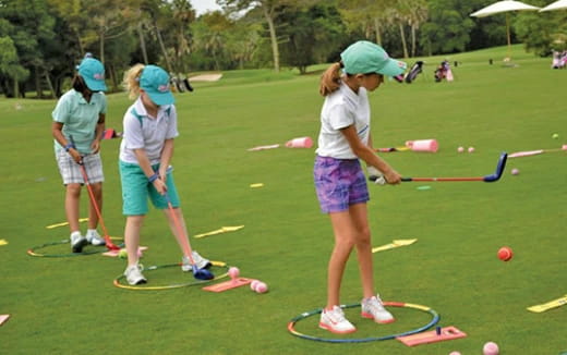 a group of girls playing golf