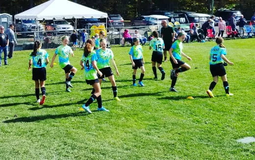 a group of girls playing football