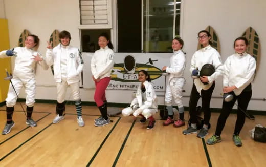 a group of people wearing white uniforms