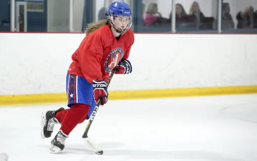 a man wearing a hockey uniform and helmet on ice