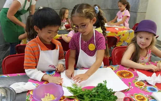 a group of children sitting at a table
