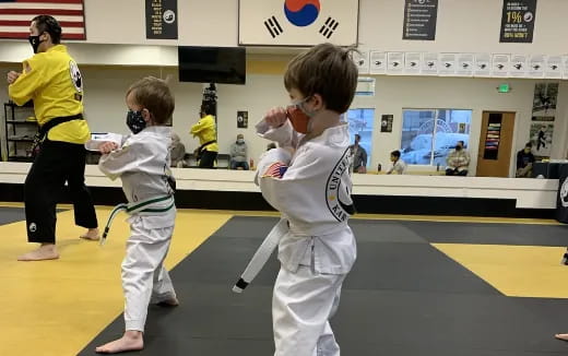 a group of kids in karate uniforms