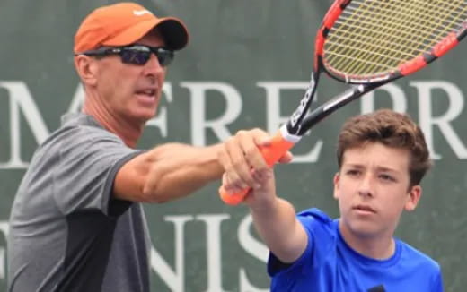 a man holding a tennis racket