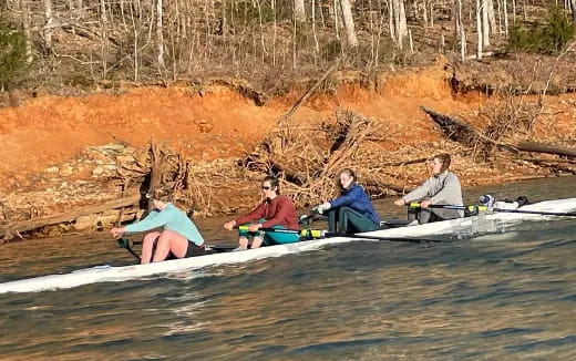 a group of people rowing a boat