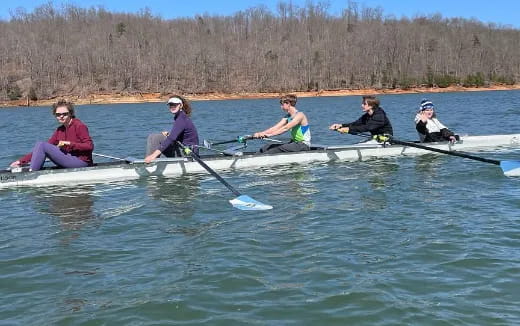 a group of people rowing a boat