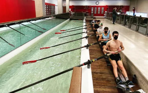 a person holding a paddle in a swimming pool