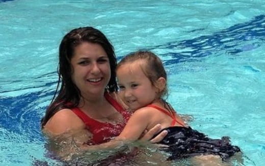 a person and a child in a pool