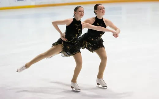 a couple of women ice skating