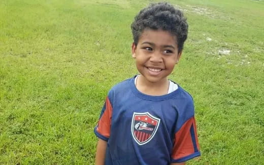 a boy smiling at the camera