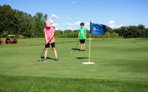 a couple of people playing golf