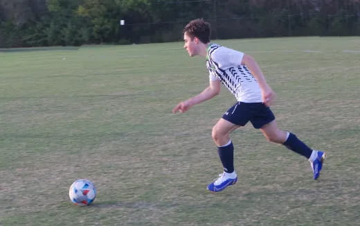 a man kicking a football ball