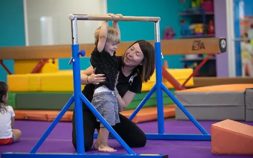 a person and a child on a bar